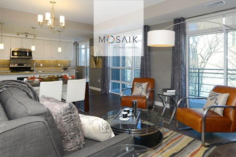 a living room and kitchen with a couch and a table